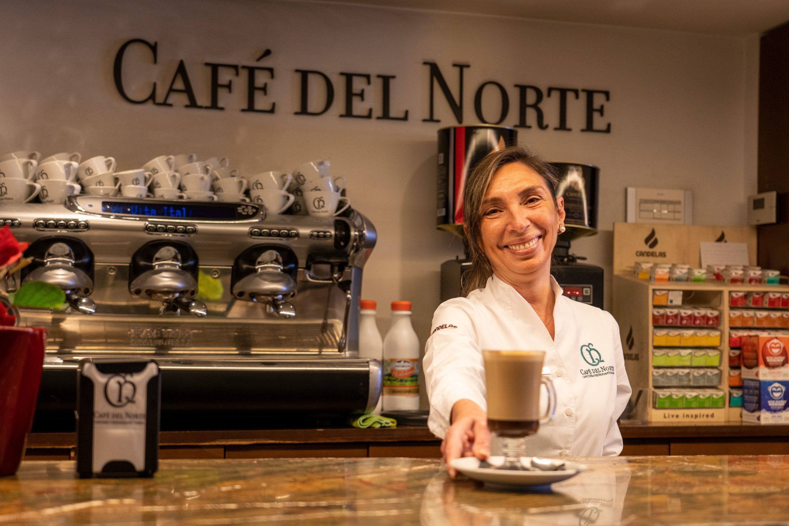 Trabajadora de la cafetería ofrece un café en la barra